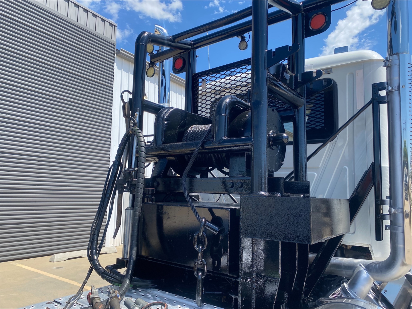 Winch-equipped Mack PI64T truck in-service showing front winch assembly and mounting frame.