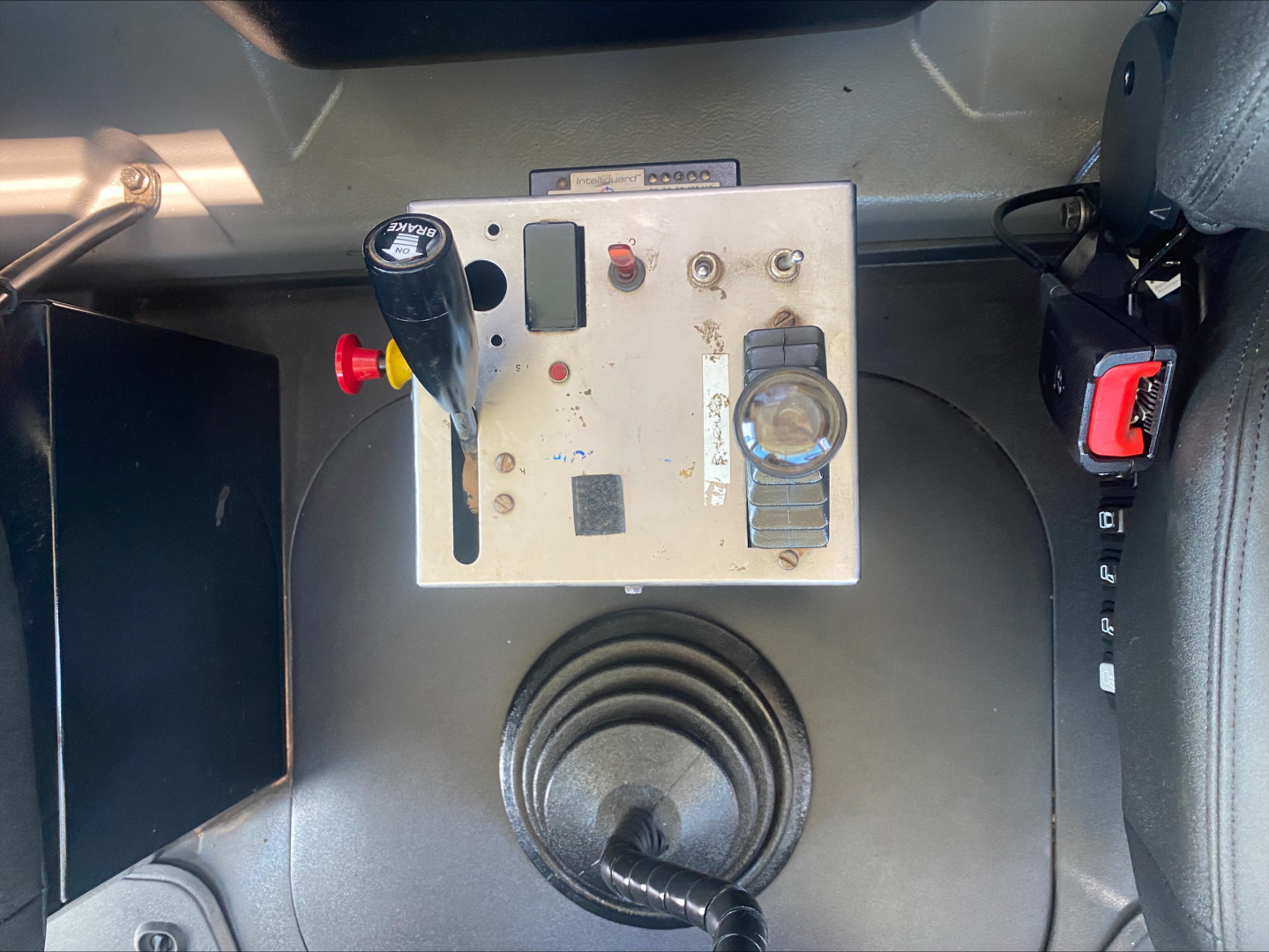 Mack PI64T winch control panel and lever inside cab showing hydraulic controls, gauges, and circular boot