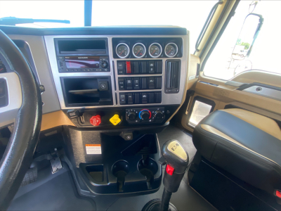 Cab interior of a 2024 Mack PI64T truck showing instrument cluster, steering column, gear shifter, and control panels.