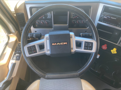 Mack PI64T steering wheel and dashboard with center Mack logo and control buttons.
