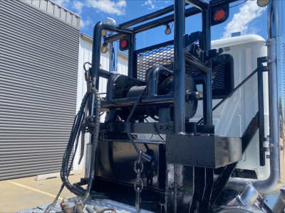 Winch-equipped Mack PI64T truck in-service showing front winch assembly and mounting frame.