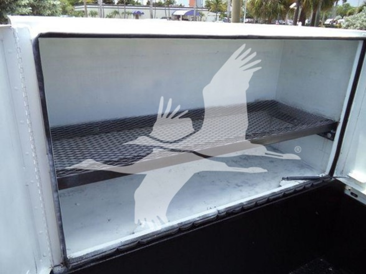 Service/Utility truck bed cargo area of a 2011 Ford F450 XLT showing empty aluminum cargo box with ribbed floor.