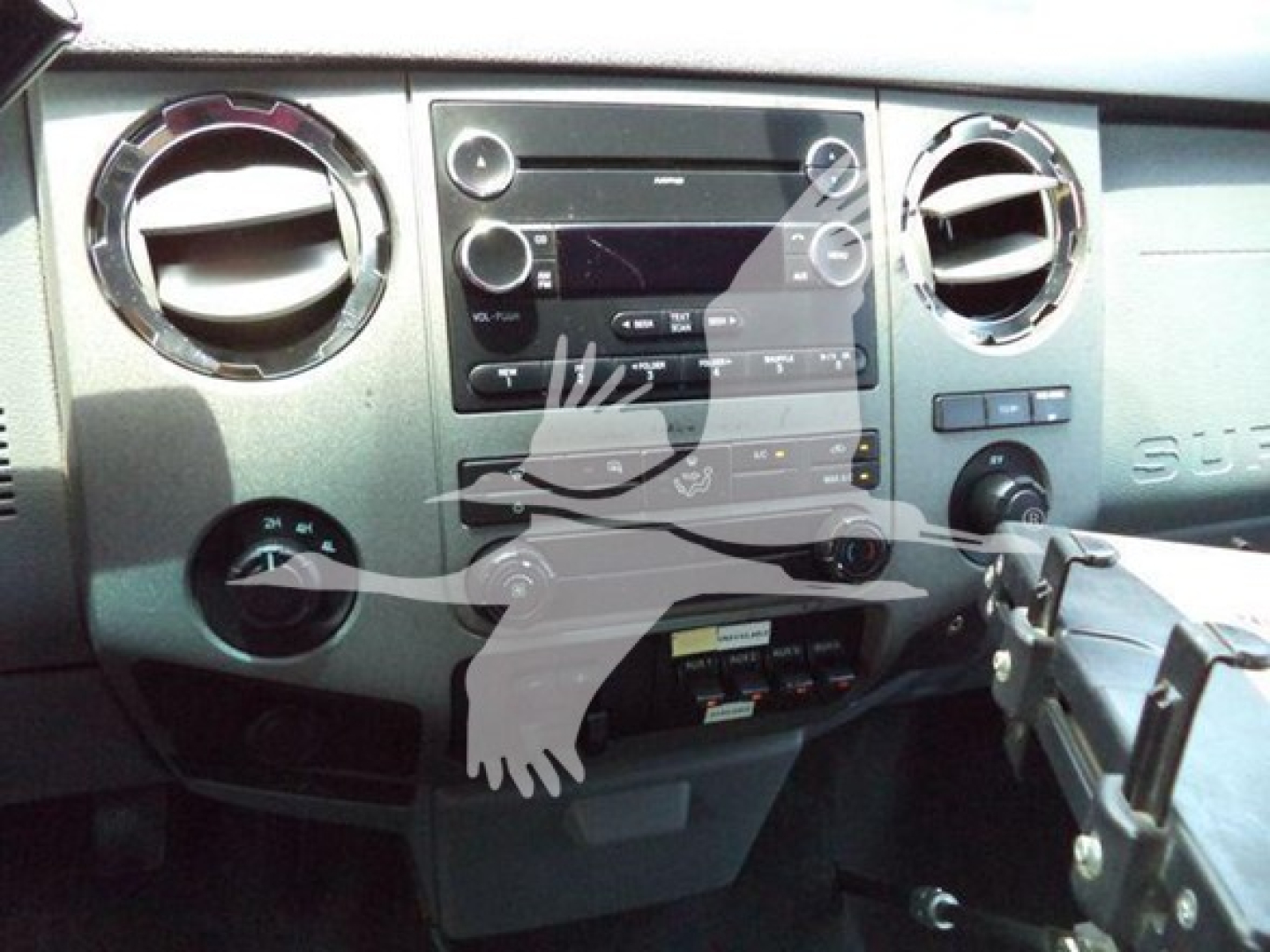Ford F-450 Super Duty dash area showing factory radio, climate vents, and control panel in a truck interior.