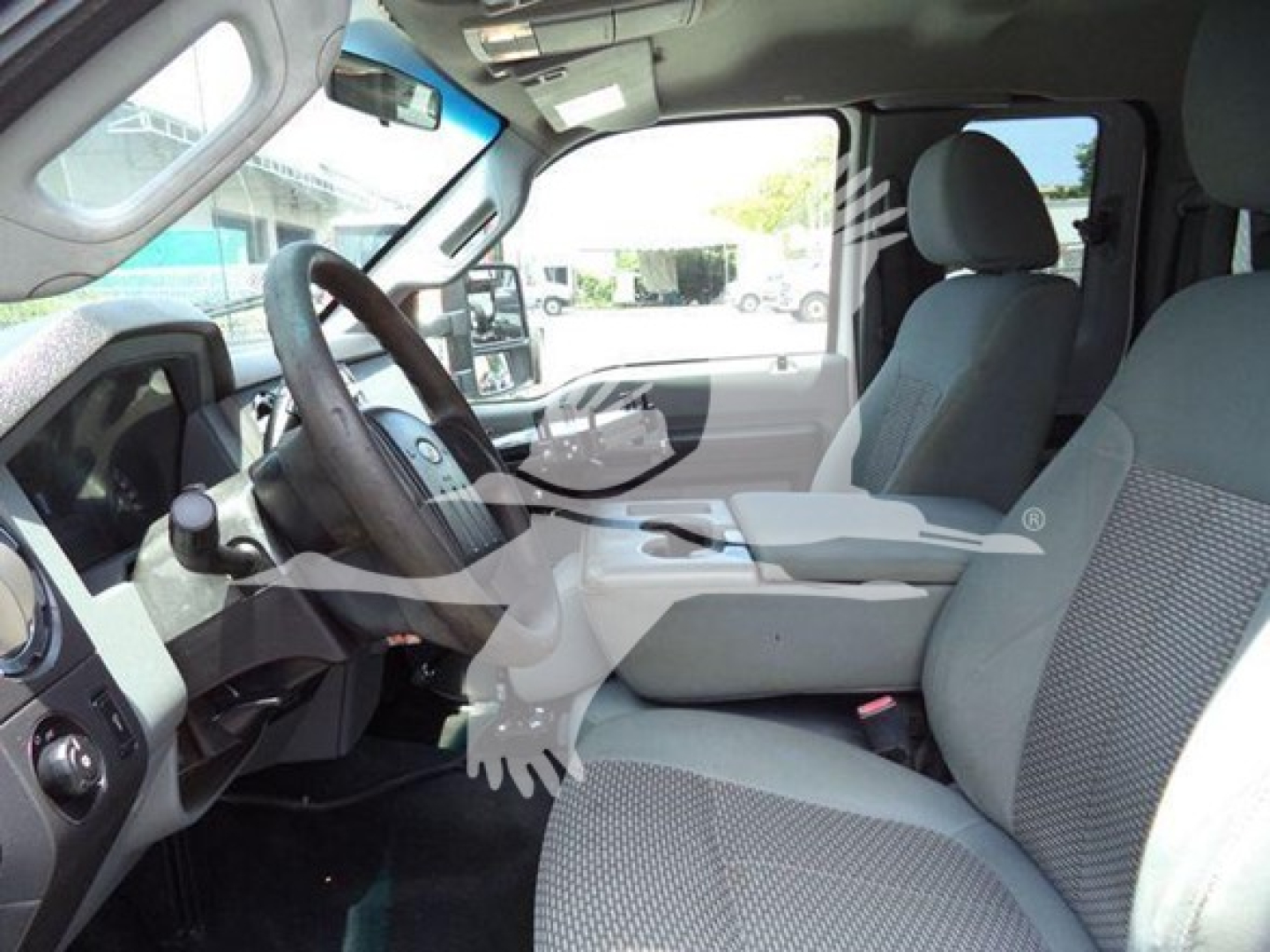 Interior of a Ford F-450 XL T series cabin showing front seats, steering wheel, and dashboard. No visible labels or fluids.