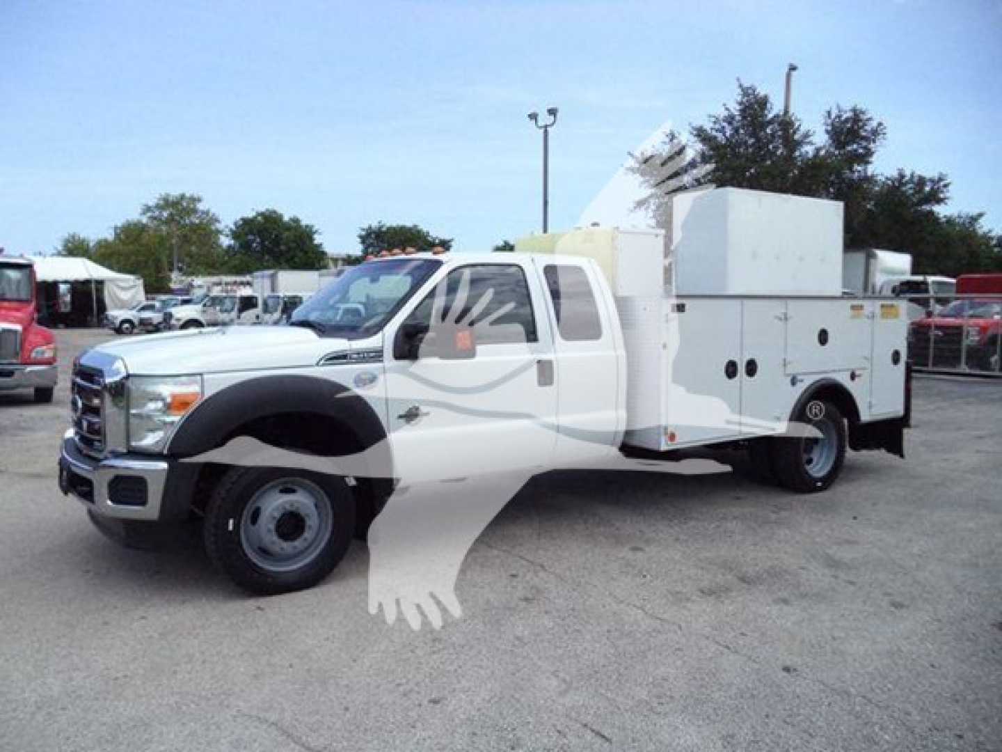 Ford F-450 service body truck in side view showing utility compartments and equipment on bed.