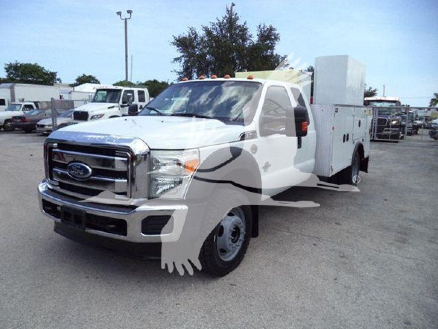Ford F-450 Super Duty service/utility truck in white, front three-quarter view with utility box on bed and cab door visible.