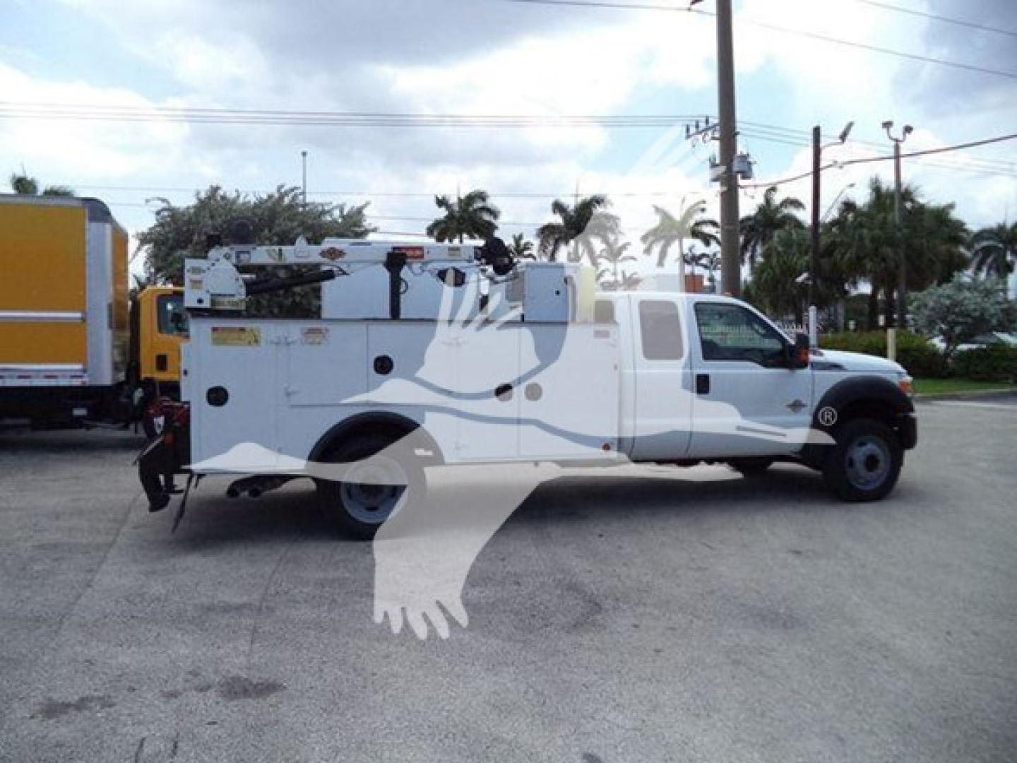 Ford F-450 service/utility truck with equipment racks and utility body, side view showing service compartments and workspace/storage rails.
