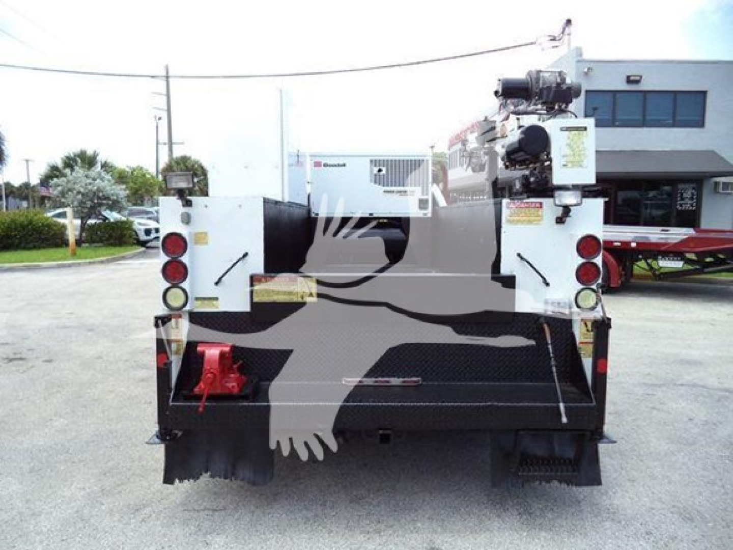 Ford F-450 service/utilities truck back view with utility equipment and hoist, rear lights, and bumper.
