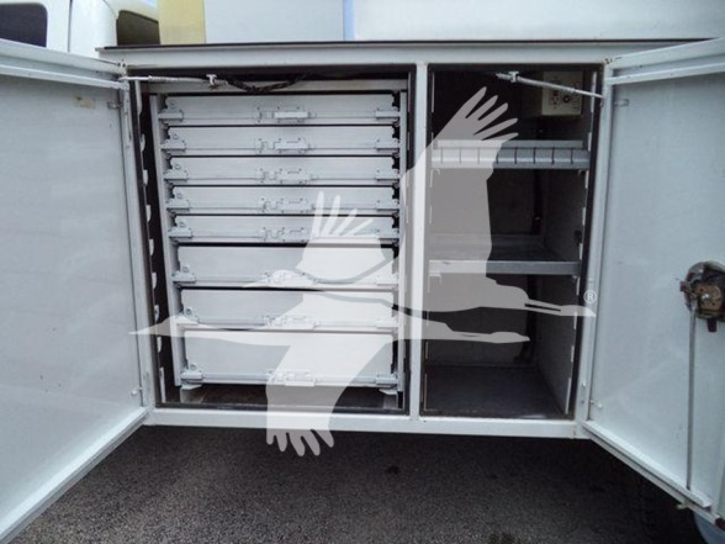 Ford F-450 utility truck rear showing multiple metal drawers and a storage compartment with shelves.
