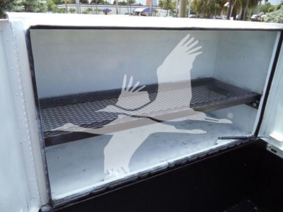 Service/Utility truck bed cargo area of a 2011 Ford F450 XLT showing empty aluminum cargo box with ribbed floor.