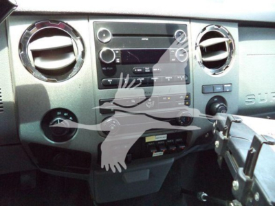 Ford F-450 Super Duty dash area showing factory radio, climate vents, and control panel in a truck interior.