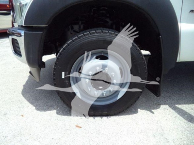 Ford F-450 front wheel well with manufactured steel rim and all-terrain tire; portion of truck fender visible