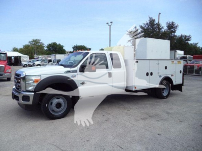 Ford F-450 service body truck in side view showing utility compartments and equipment on bed.