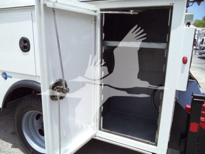 Ford F-450 utility truck cargo area with open rear doors and empty cargo space.