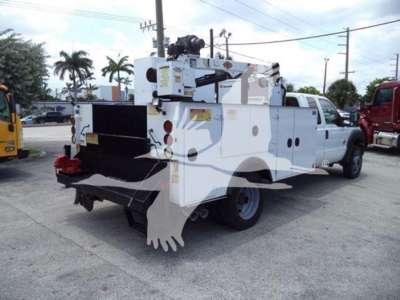 Ford F-450 service utility truck with mounted crane and utility compartments, rear view showing toolbox and equipment rack.