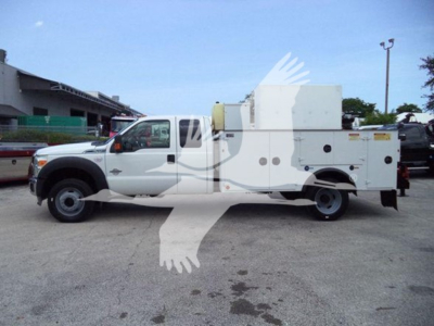 Ford F-450 utility service truck side view showing service body compartments and storage bays.