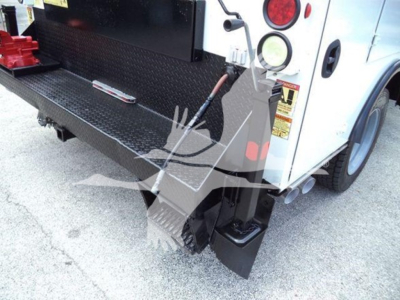 Rear view of a Ford F-450 utility truck showing the cargo platform and rear bumper with step, tail lights, and platform edge; notations on left side panel visible.