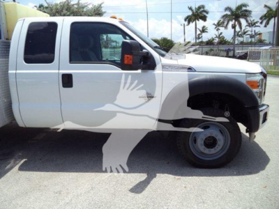 Ford F-450 Super Duty utility truck side view showing extended cab, front quarter panel, and dual rear wheels with white paint.