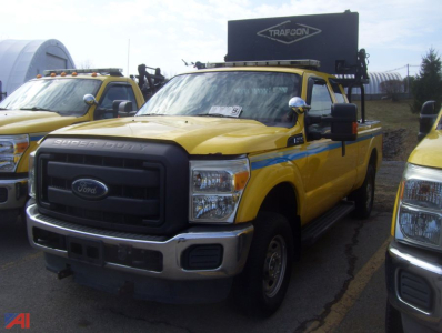 Ford F-250 Super Duty pickup truck in yellow with service body, front grille and Ford emblem visible.