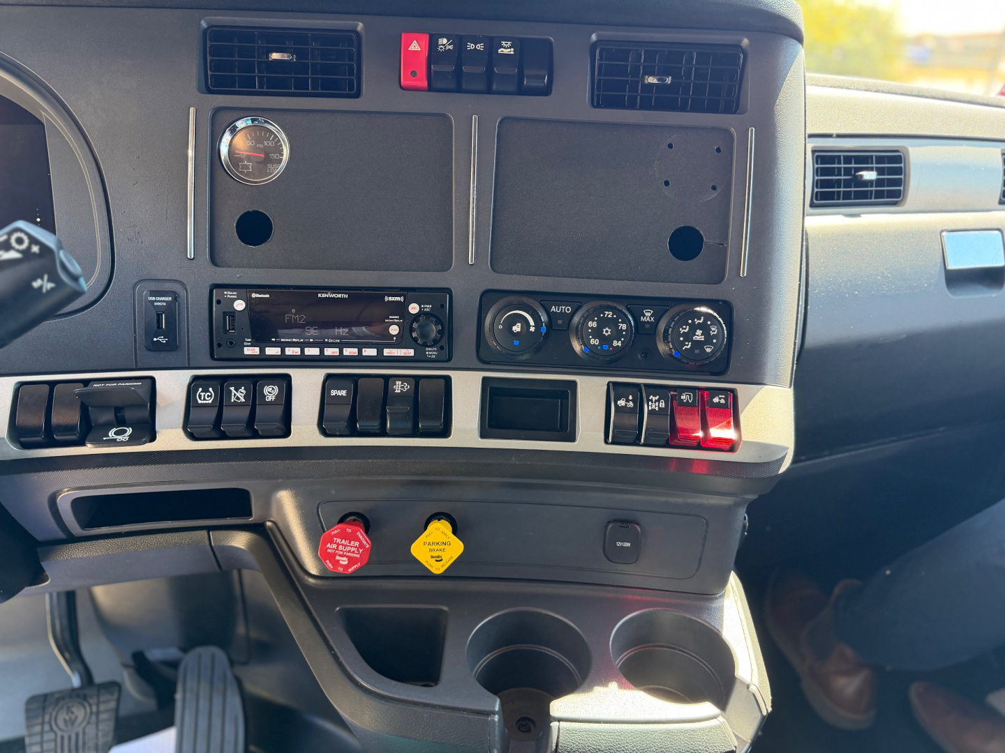 Kenworth T680 truck interior dashboard panel with vents, gauges, and switches visible.