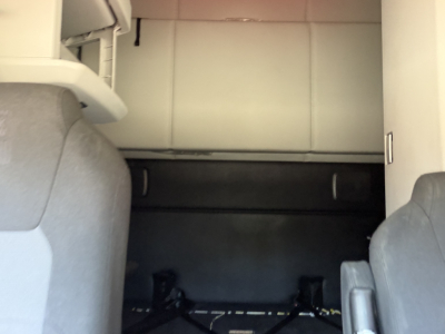 Truck interior showing sleeper area and cargo space in a Kenworth T680 cab.