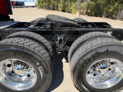 Truck rear duals showing Goodyear tires on polished chrome wheels and fifth wheel area visible.