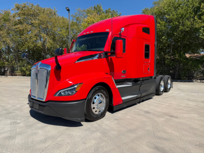 Kenworth T680 truck in red with sleeper cab, front-left view, showing chrome grille and dual rear axles.