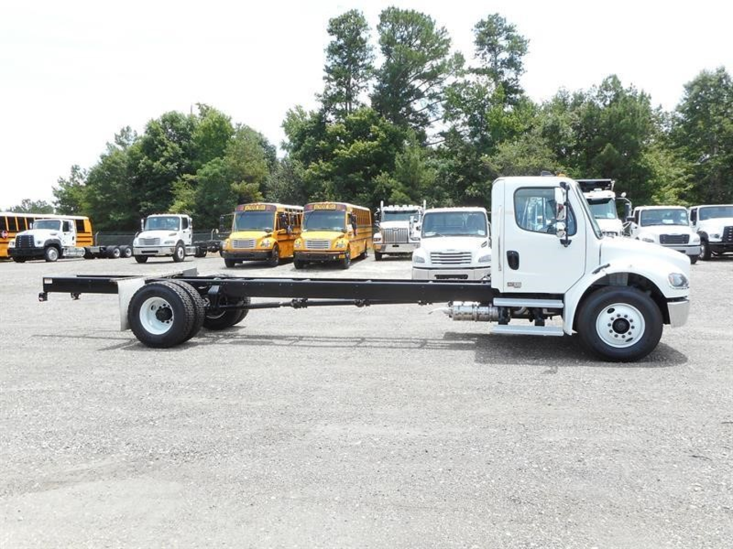 Freightliner M2 106 cab and chassis truck side view showing bare frame and white cab.