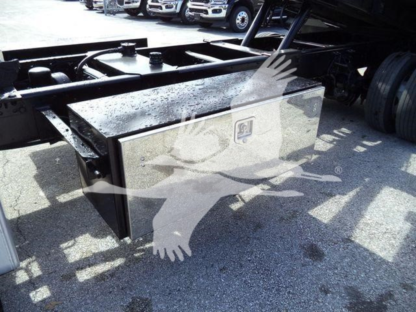 Hino truck chassis with side storage box and metal frame components visible; no legible text on the box.