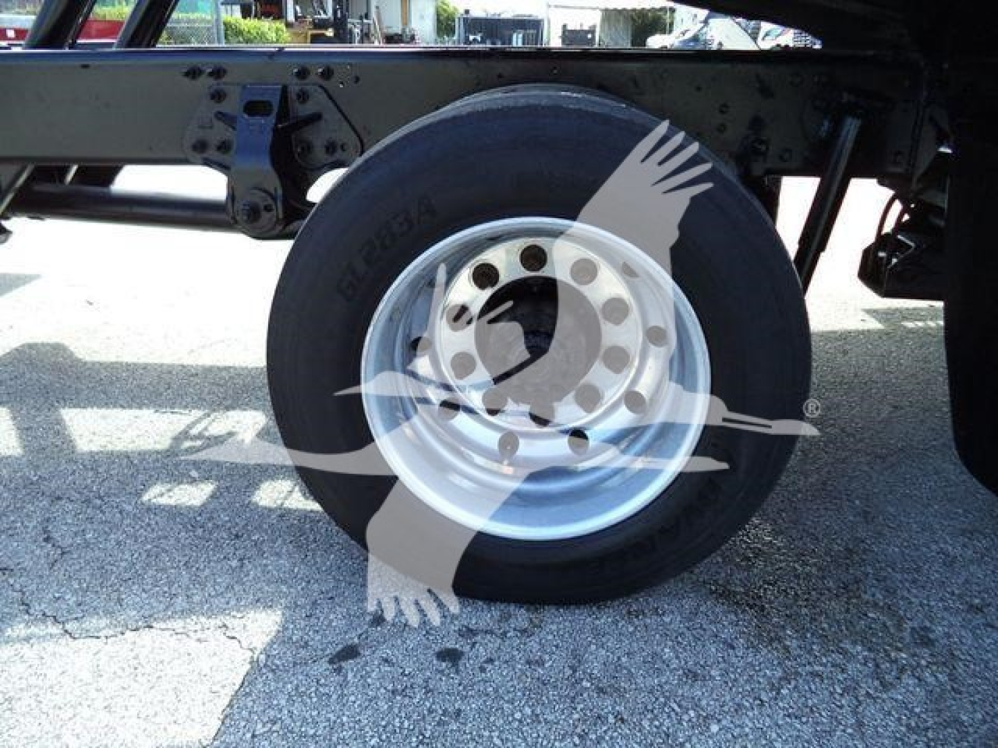 Hino 258Al rollback truck wheel and suspension showing front axle and tire with wheel hub.