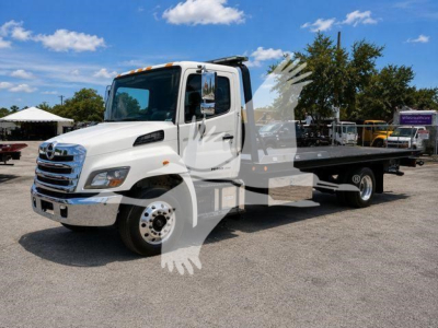 White 2020 Hino 258Al rollback tow truck, listing details visible in photo with VIN and stock number not shown on image.
