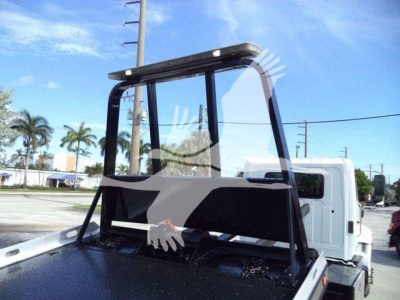 Truck cab with rollover rollback apparatus mounted on flatbed showing overhead guard and rear frame components.