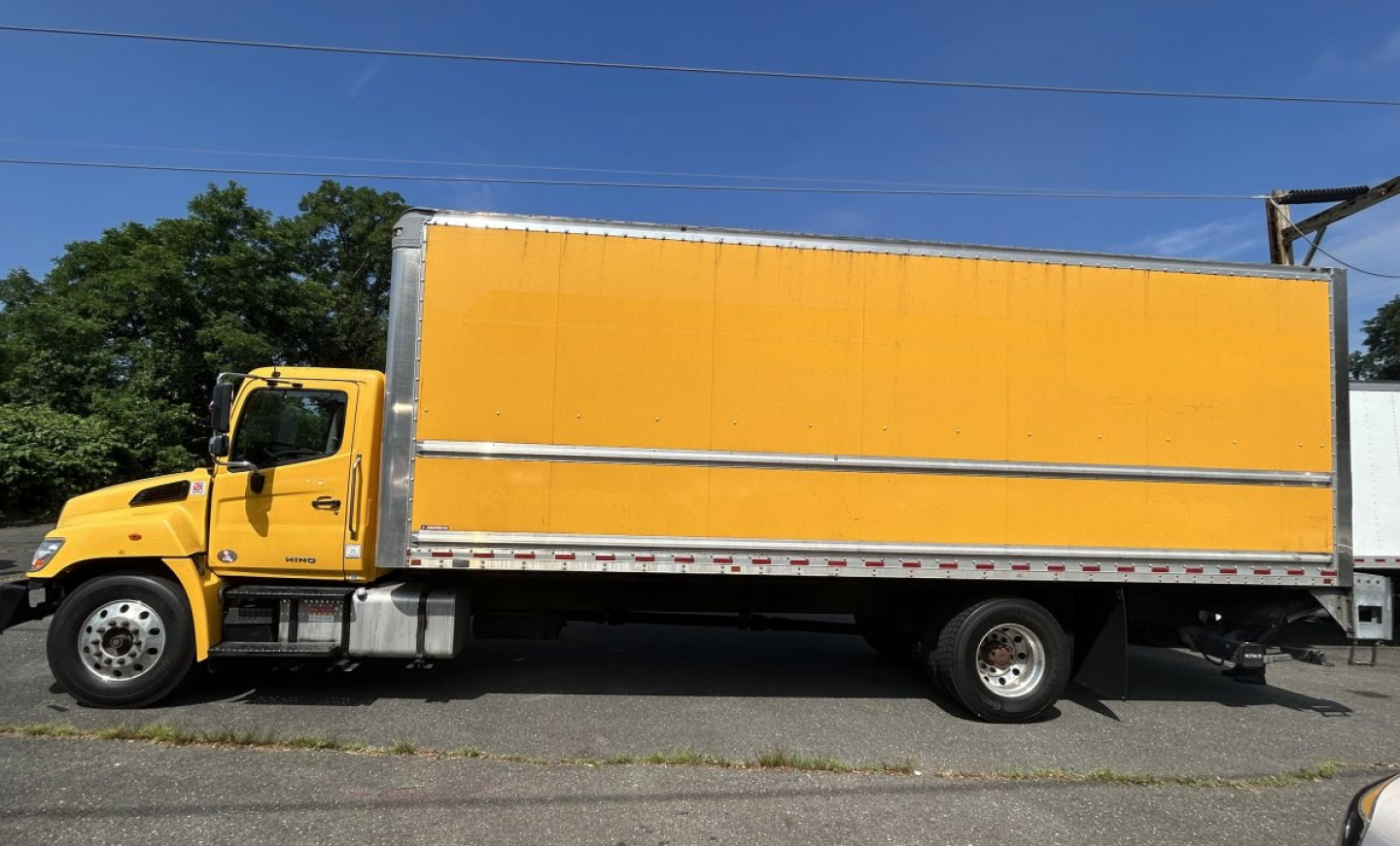 Box truck side view showing a yellow Hino 338 with a large orange cargo box and boxed trailer, stock number 8269T, VIN 5PVNV8JV5L4S59645.