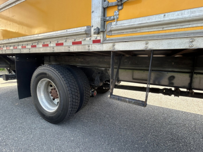 Hino 338 box truck rear wheel area showing dual rear wheels and undercarriage components
