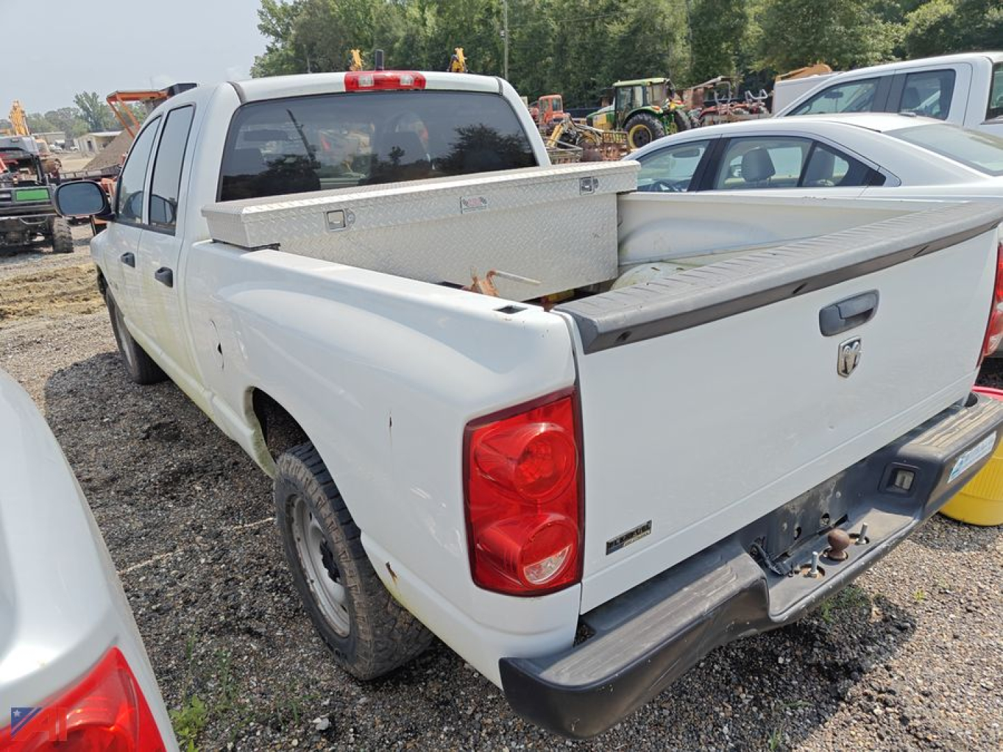 Rear-left view of a white 2008 Dodge Ram 1500 Crew Cab pickup with a diamond plate toolbox in the bed and a raised tailgate.