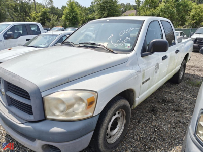 Truck in a used car lot: white 2008 Dodge Ram 1500 Crew Cab pickup, two-wheel drive, front-left view.