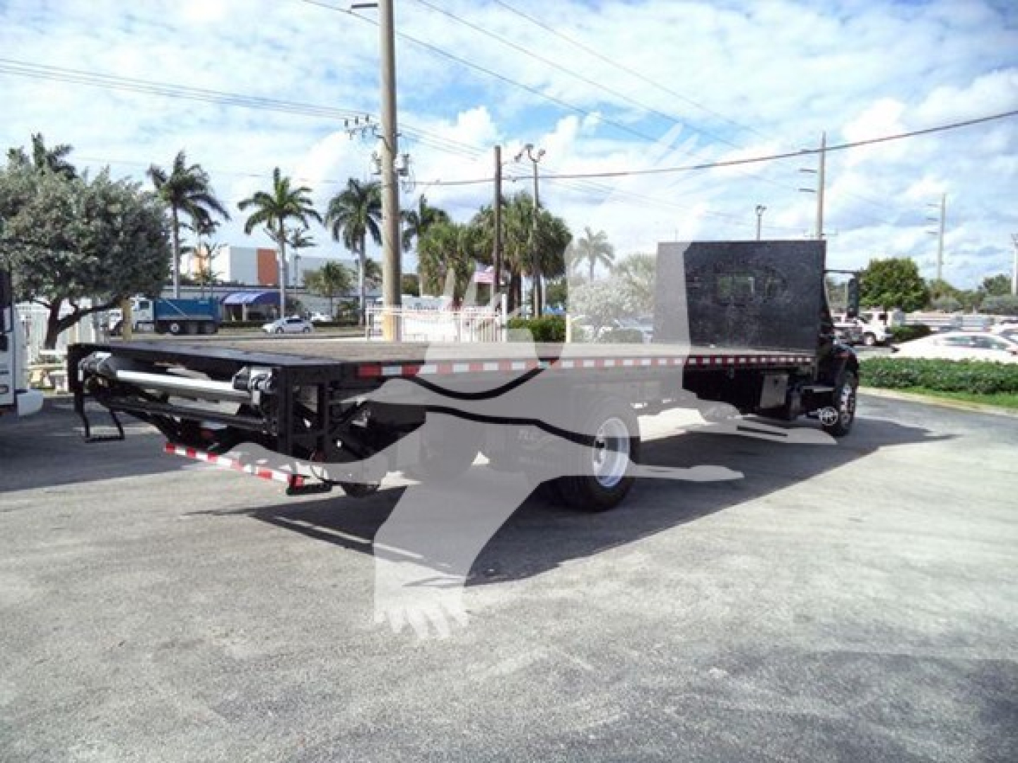 Flatbed tow truck chassis showing long deck and rear equipment on a 2019 International Durastar 4300