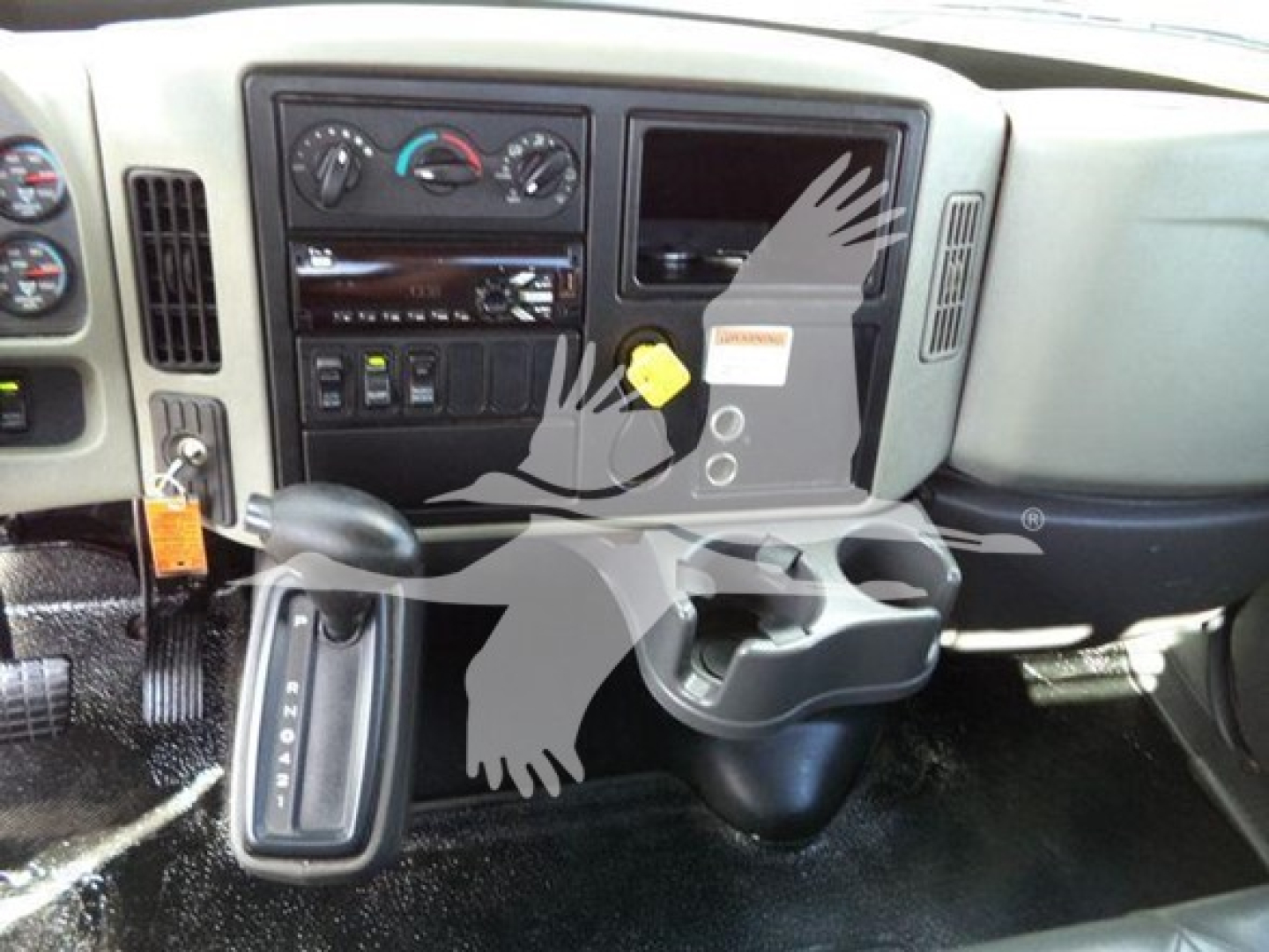 Vehicle interior dashboard of a 2019 International Durastar 4300 showing steering column, gear selector, climate controls, and instrument cluster.