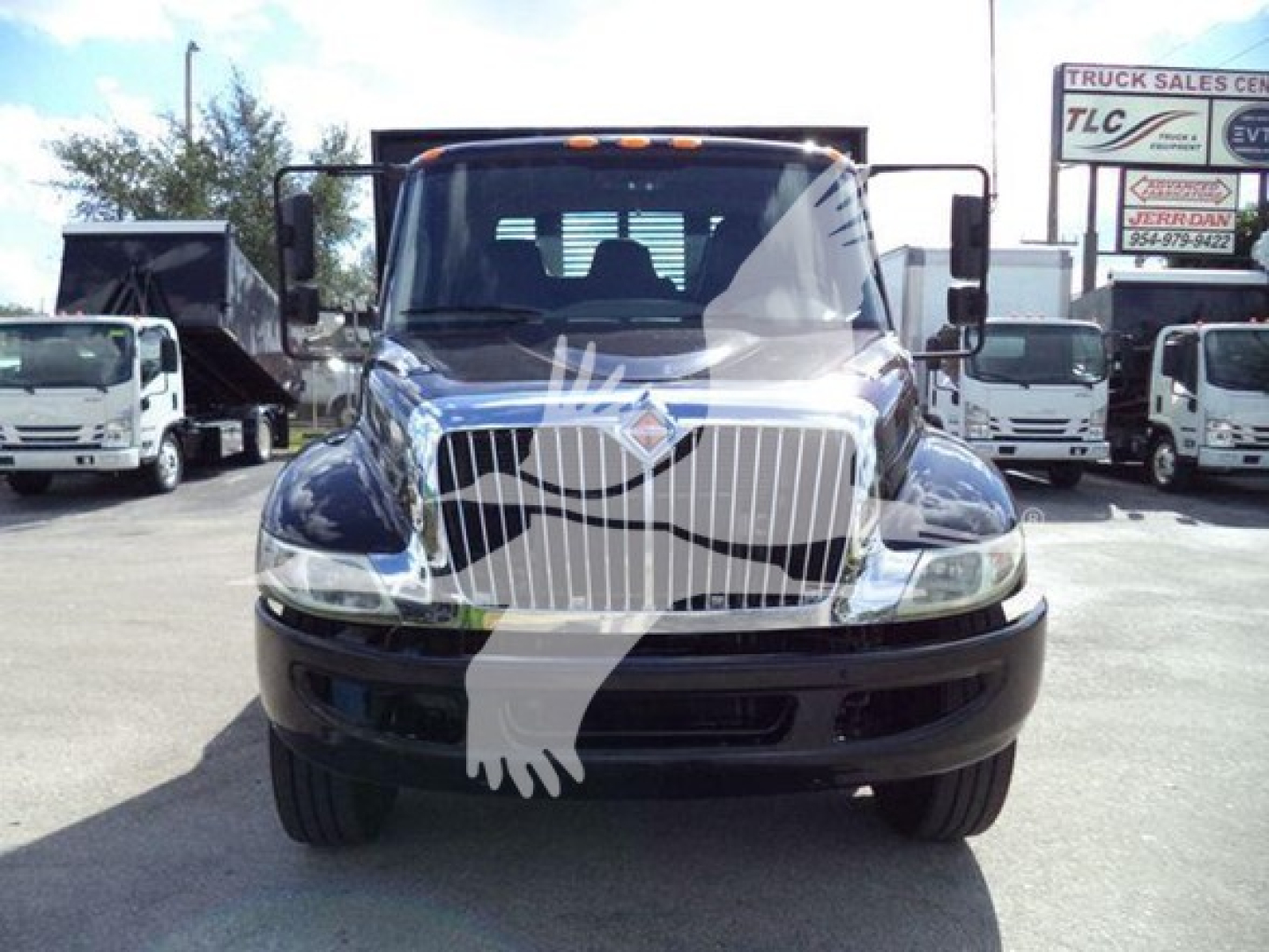 International Durastar 4300 flatbed truck facing front showing chrome grille and headlights.