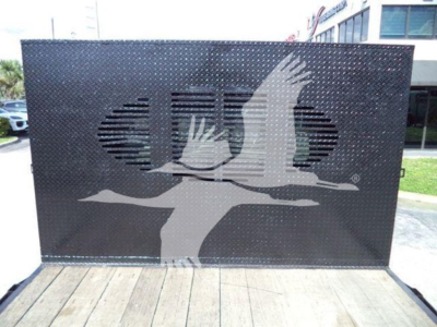 Flatbed truck equipment image showing a diamond plate metal ramp with a graphic logo, no visible text or labels.