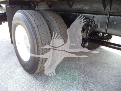 Truck rear axle with dual tires and suspension components visible under flatbed on International Durastar 4300