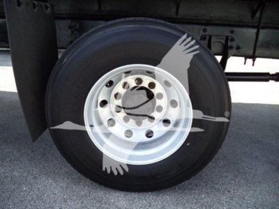 International Durastar 4300 flatbed truck wheel and tire with fender and undercarriage components visible