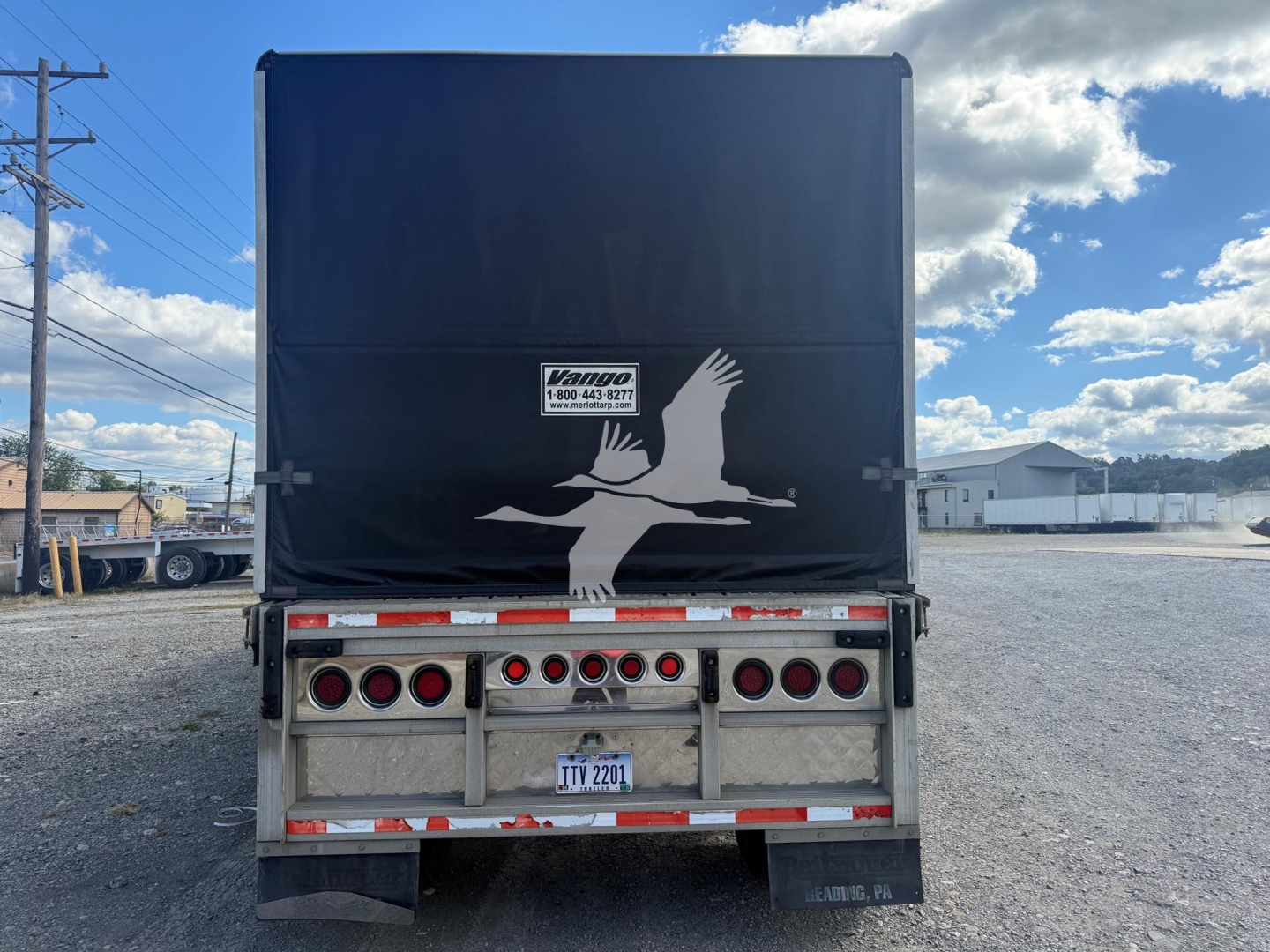 Trailer rear view of a 2006 Reitnouer Maxmiser curtainside trailer showing the back with a large white bird graphic and Vanco Trailers logo plate, multiple round taillights, and a license plate.