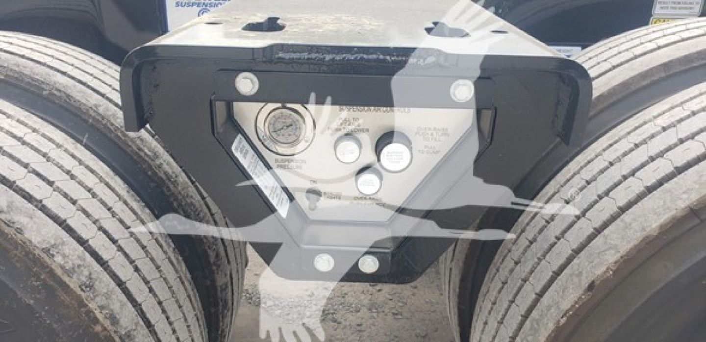Trailer hitch plate on Fontaine 55Mx lowboy showing attachment bolts and label area with bolts and circular sensors.