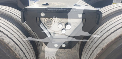 Trailer hitch plate on Fontaine 55Mx lowboy showing attachment bolts and label area with bolts and circular sensors.
