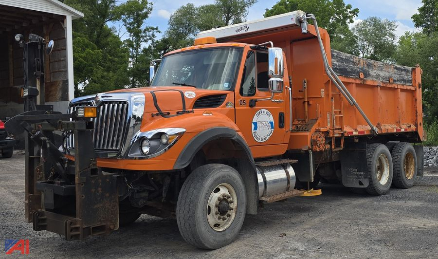 International WorkStar 7600 dump truck with plow attached, orange cab and dump bed, front mounted snow plow, in-service condition
