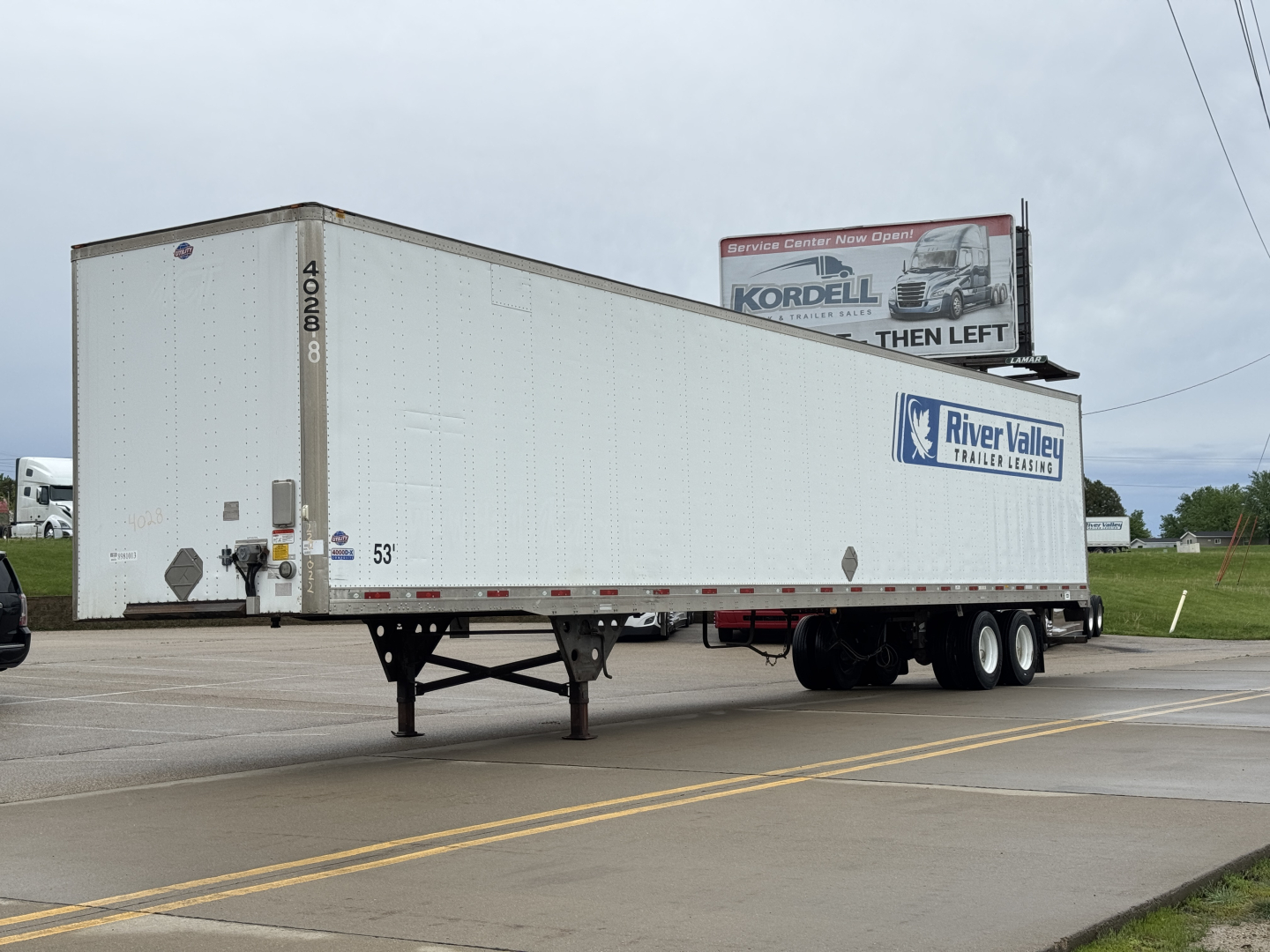 Utility 4000DX trailer in view showing white trailer with River Valley trailer sales logo and rear doors, 53' length, front area over hitch.