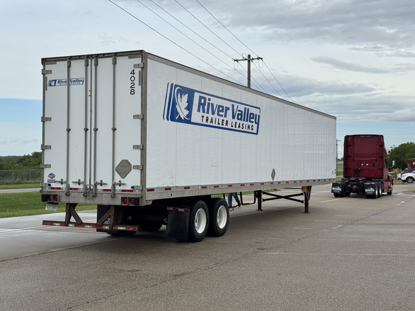 Trailer side and rear of a River Valley Leasing utility trailer with Delta markings and dual rear doors.