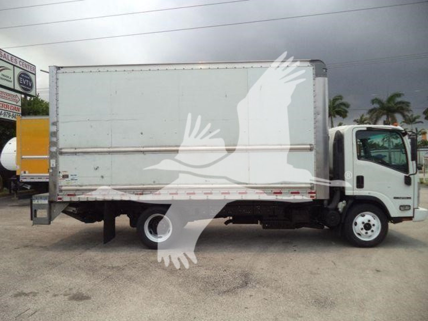 Isuzu NPR HD box truck side view showing cargo box and cab with white exterior.