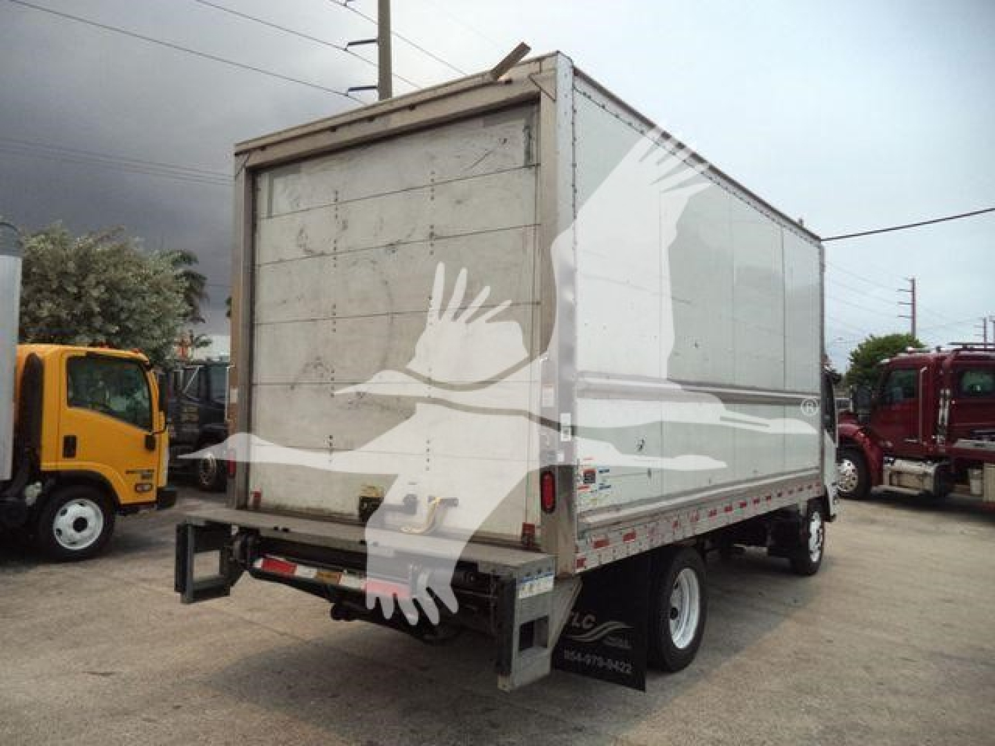 Isuzu NPR-HD box truck rear view showing cargo box and dual rear tires.